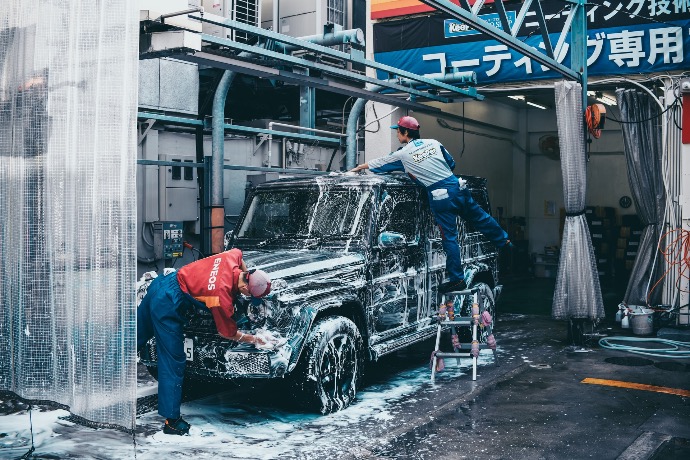 two men washing black SUV